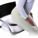 A girl sits down on a chair with an orthopedic pillow