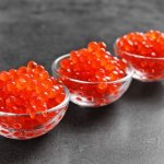 three sauceboats with red caviar